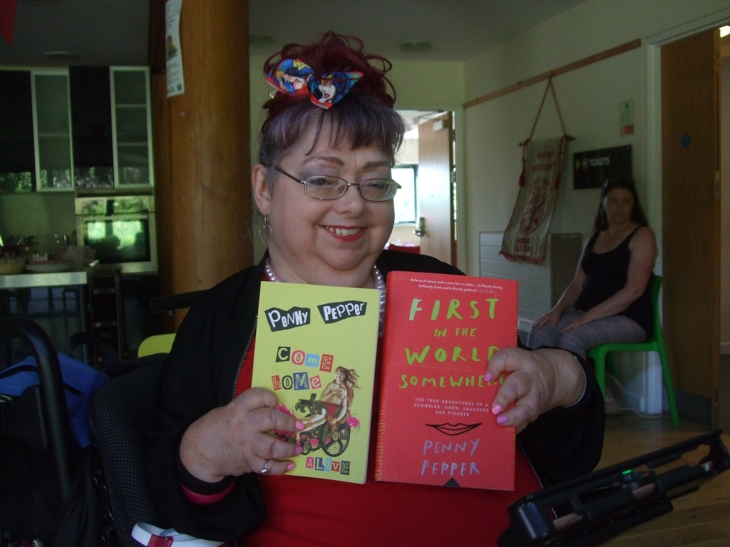 Penny Pepper with her book of poetry and her memoir, "First in the world somewhere"